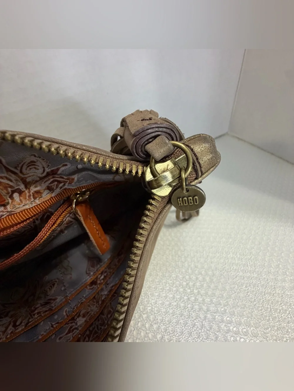 HOBO Metallic Bronze Studded Wristlet Tote with Tassel